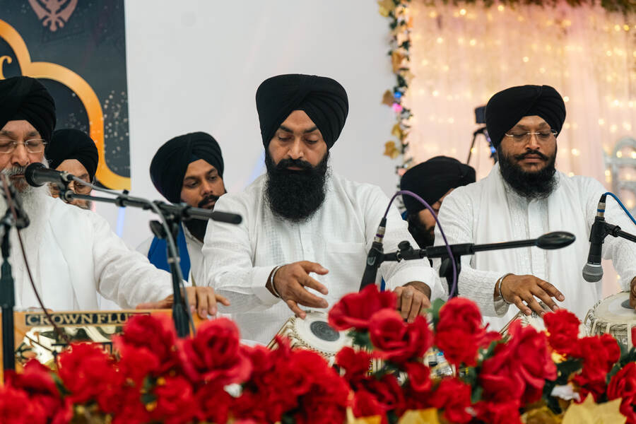 Ragis and tabla players performing kirtan